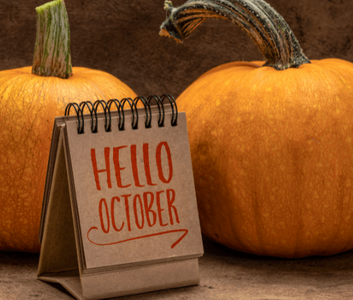 Hello October sign in front of pumpkins